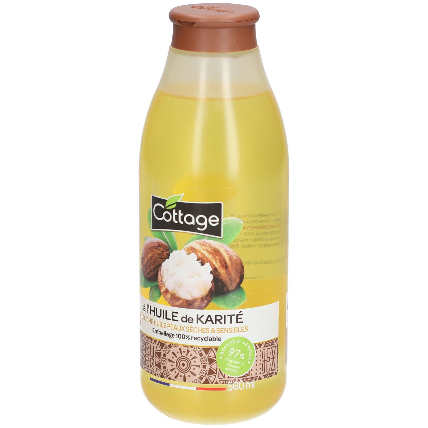 Huile de douche Cottage Karité en flacon transparent avec bouchon marron. Contient des noix de karité, pour peaux sèches et sensibles.