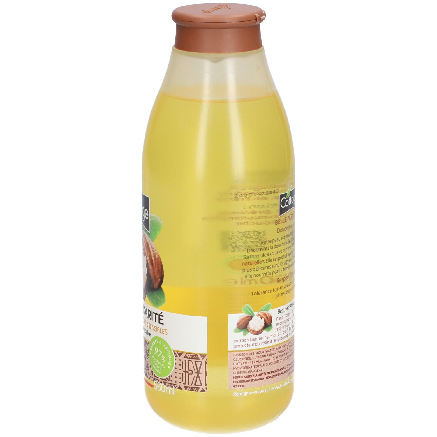 Liquide jaune dans une bouteille transparente avec un bouchon marron. Étiquette avec motif de noix de karité et texte.