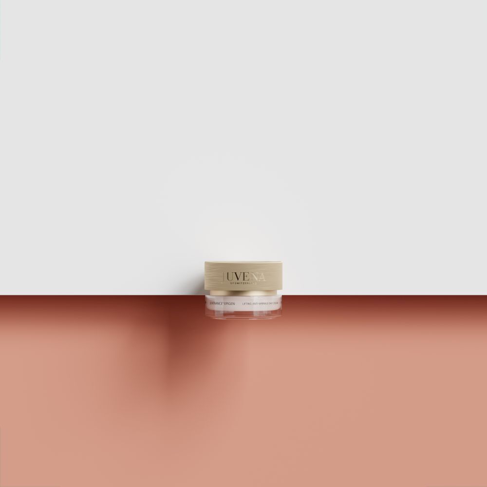 Pot de crème avec couvercle doré. Inscription: Juvena. Sur fond rouge et blanc.