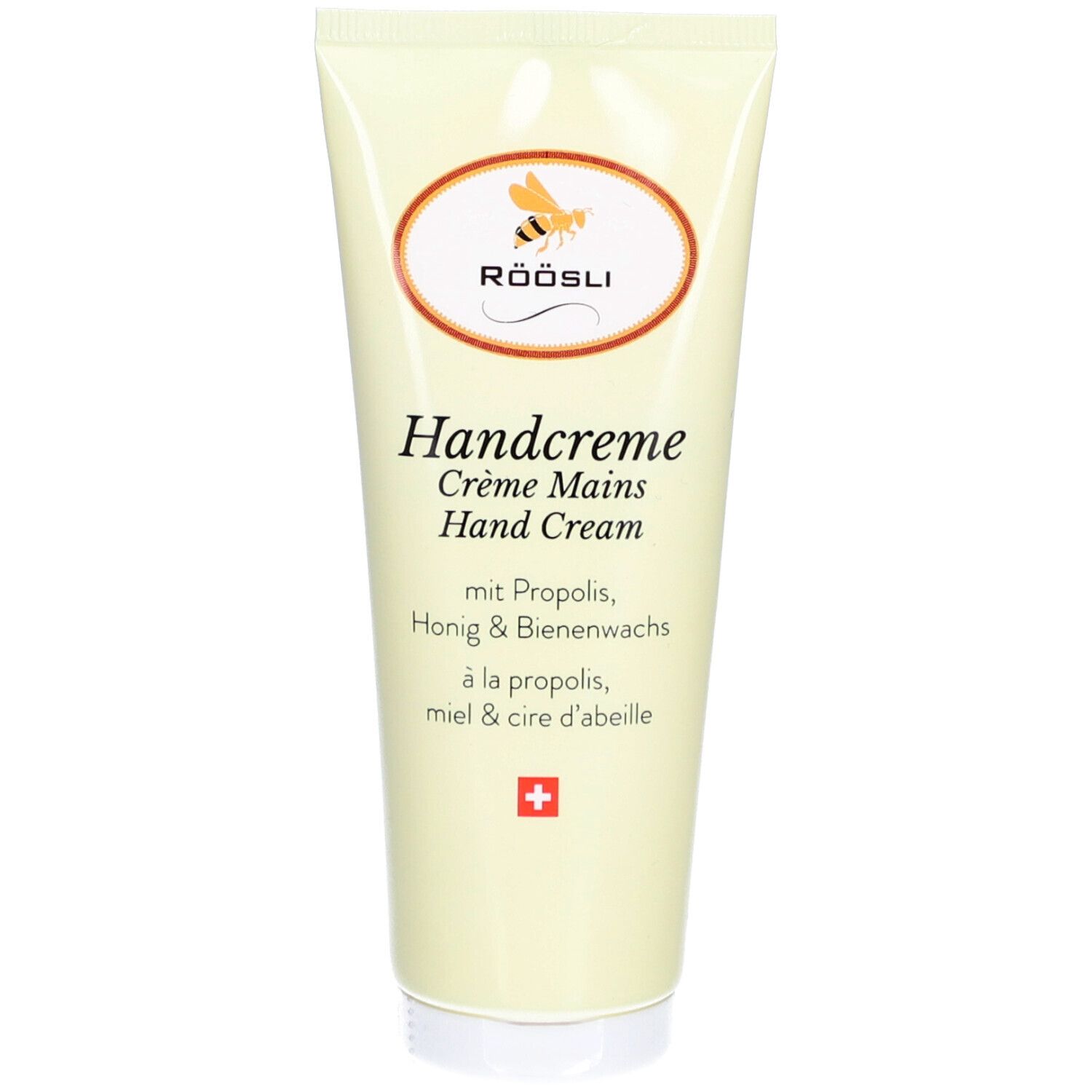 Tube de crème avec logo et texte. Contient de la propolis, du miel et de la cire d'abeille. Croix suisse.