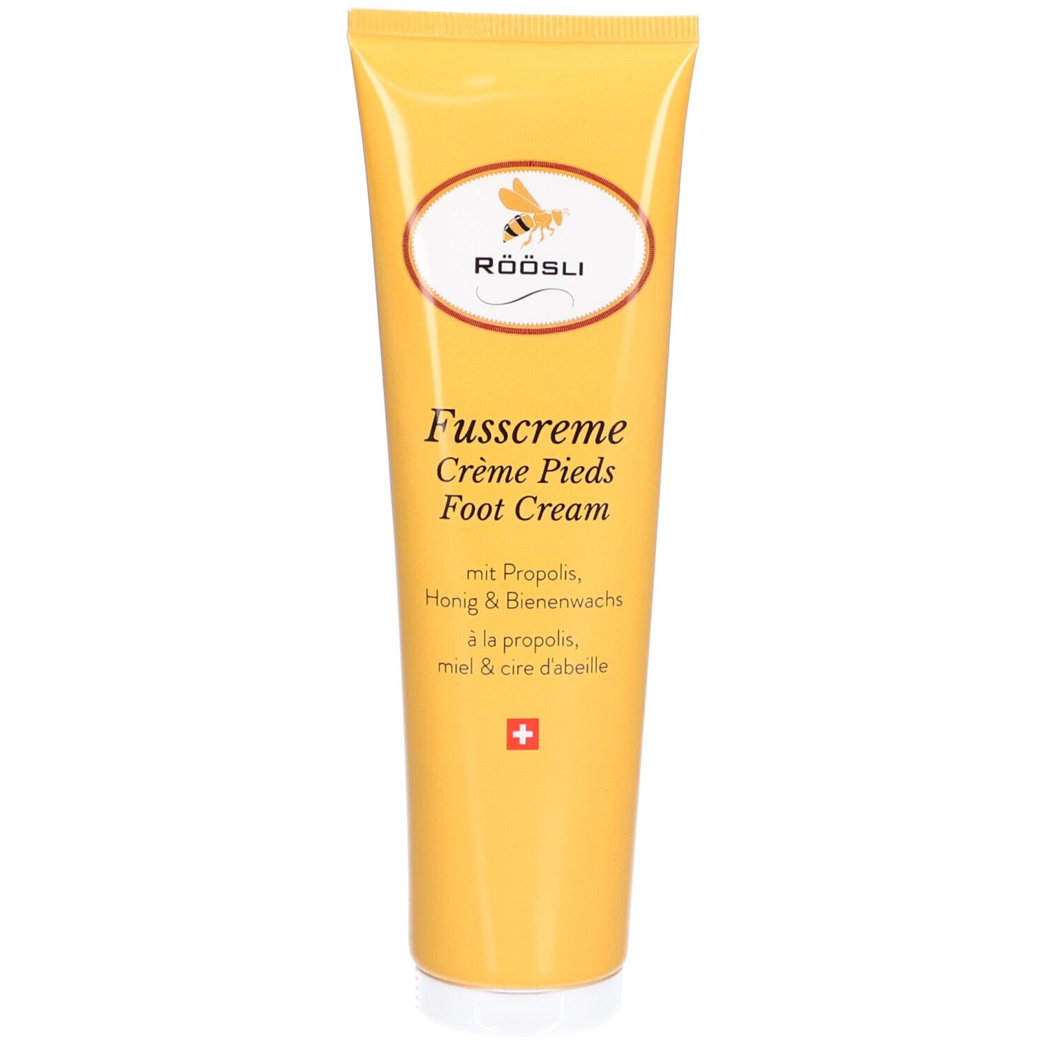 Tube jaune de RÖÖSLI Fusscreme. Logo abeille. Texte: Fusscreme, Crème Pieds, Foot Cream. Croix suisse.