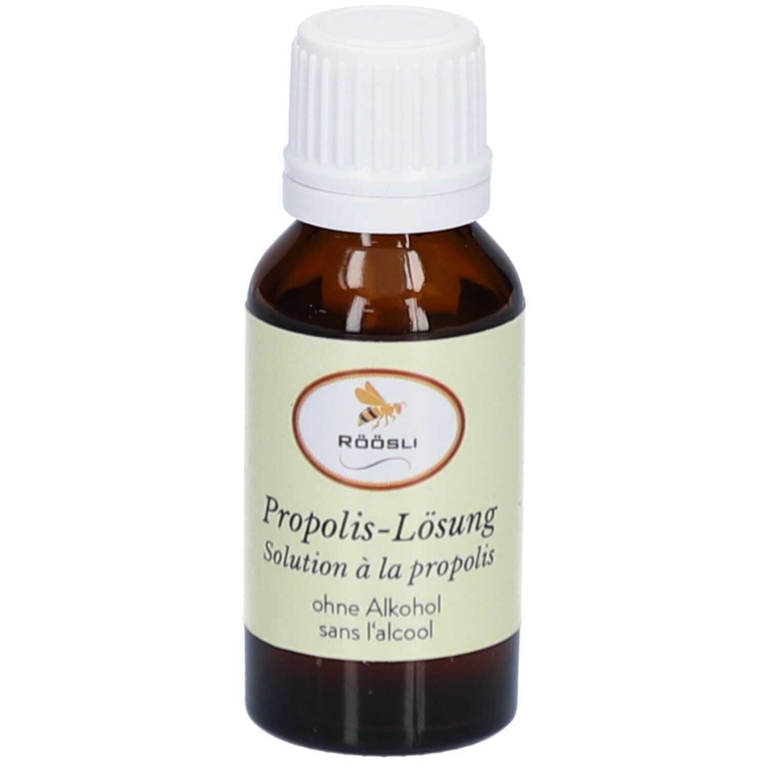 Flacon en verre brun avec bouchon blanc. Étiquette avec nom du produit, marque RÖÖSLI et sans alcool. Solution.