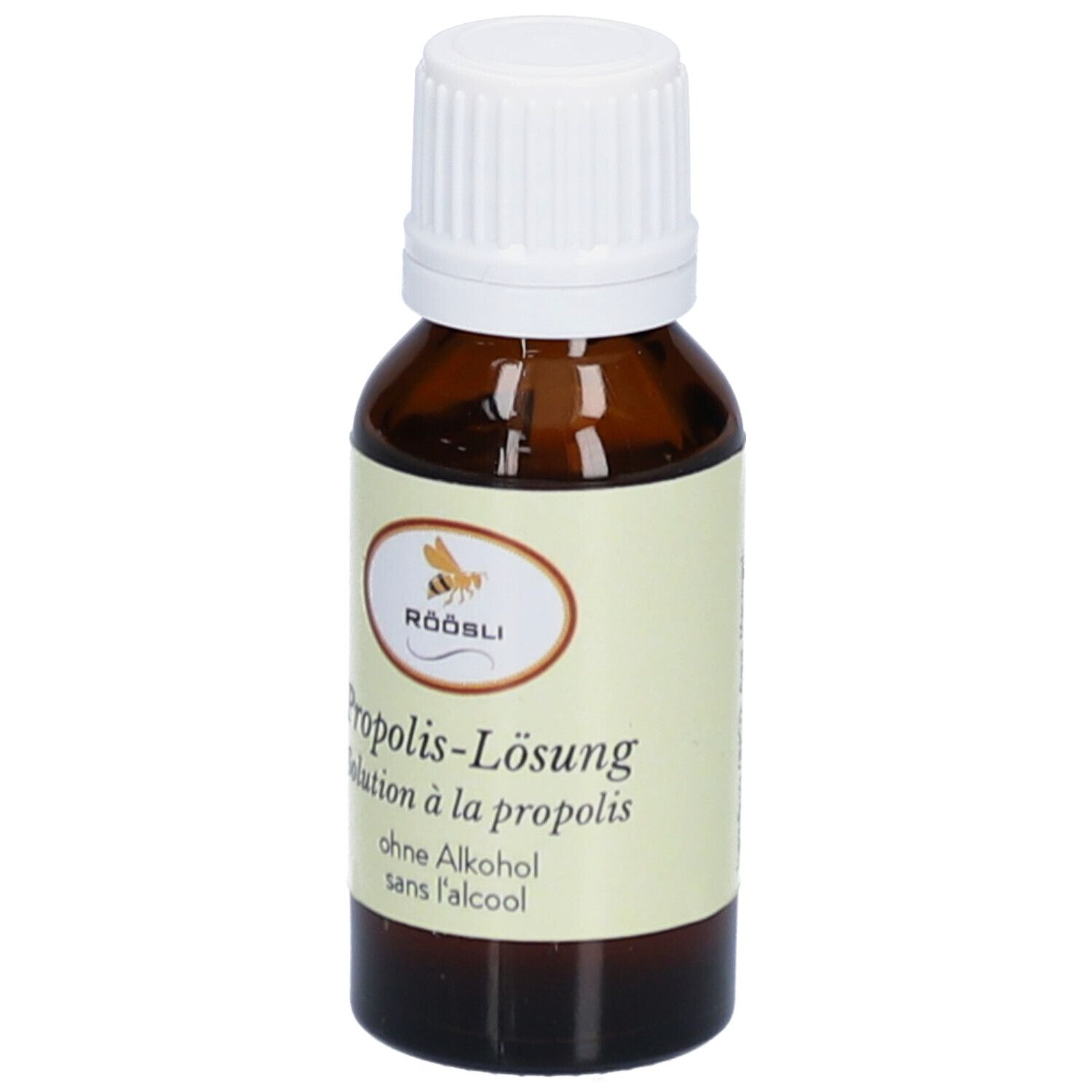 Flacon en verre brun avec bouchon blanc. Étiquette avec nom du produit, marque RÖÖSLI et sans alcool. Solution.