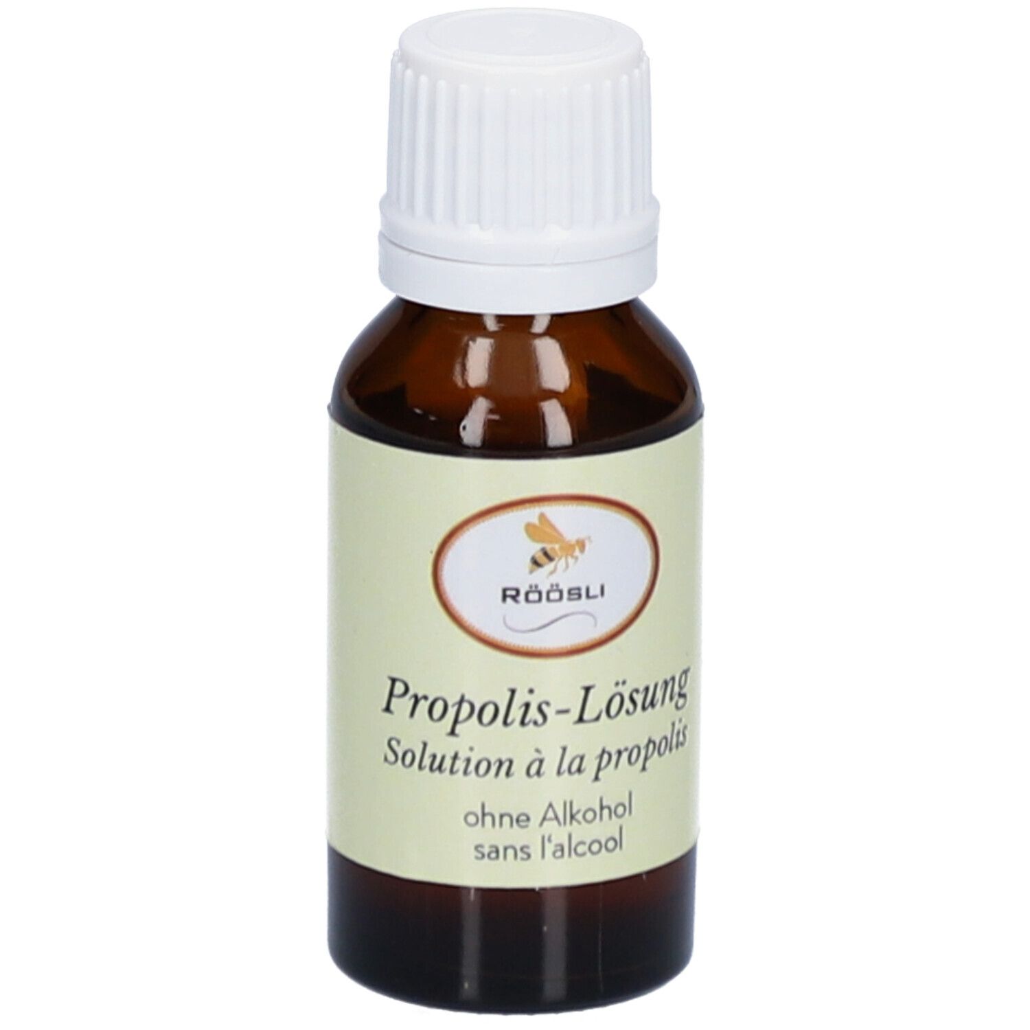 Flacon en verre brun avec bouchon blanc. Étiquette avec nom du produit, marque RÖÖSLI et sans alcool. Solution.