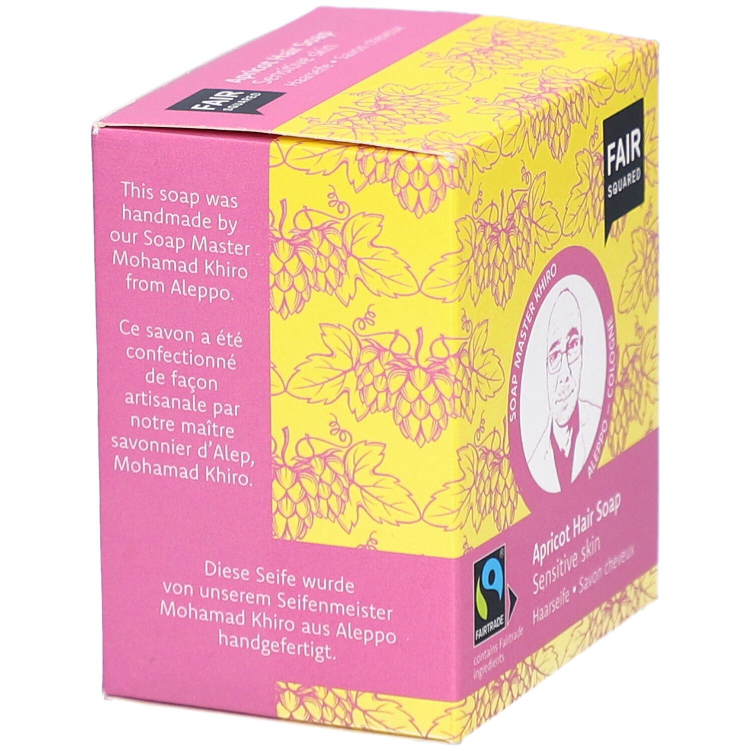 Emballage de savon capillaire. Texte: fait à la main par Soap Master Khiro d'Alep. Label FAIRTRADE. Fond jaune avec motif de raisins.