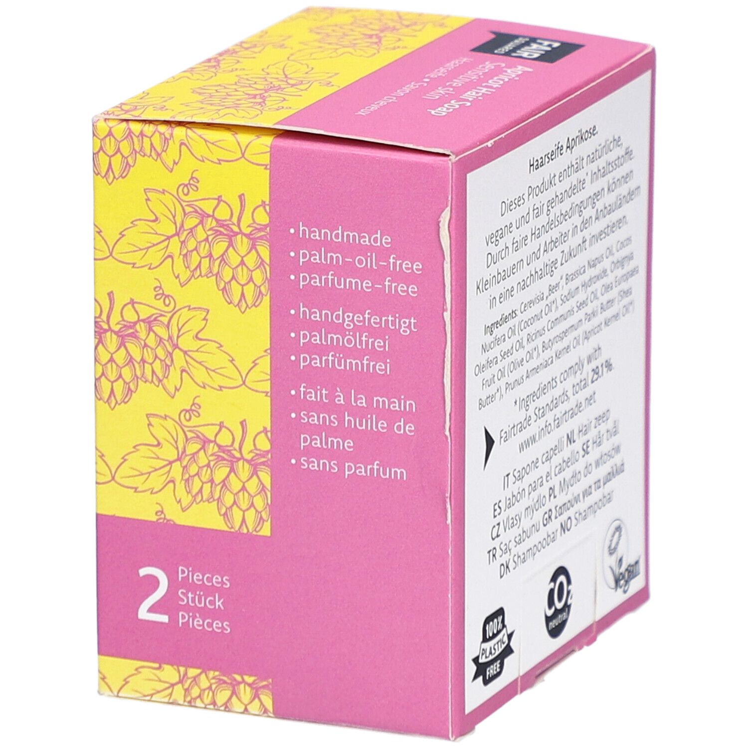 Emballage de savon capillaire. Texte: fait à la main, sans huile de palme, sans parfum. 2 pièces. Fond jaune avec motif de raisins. Label Vegan.