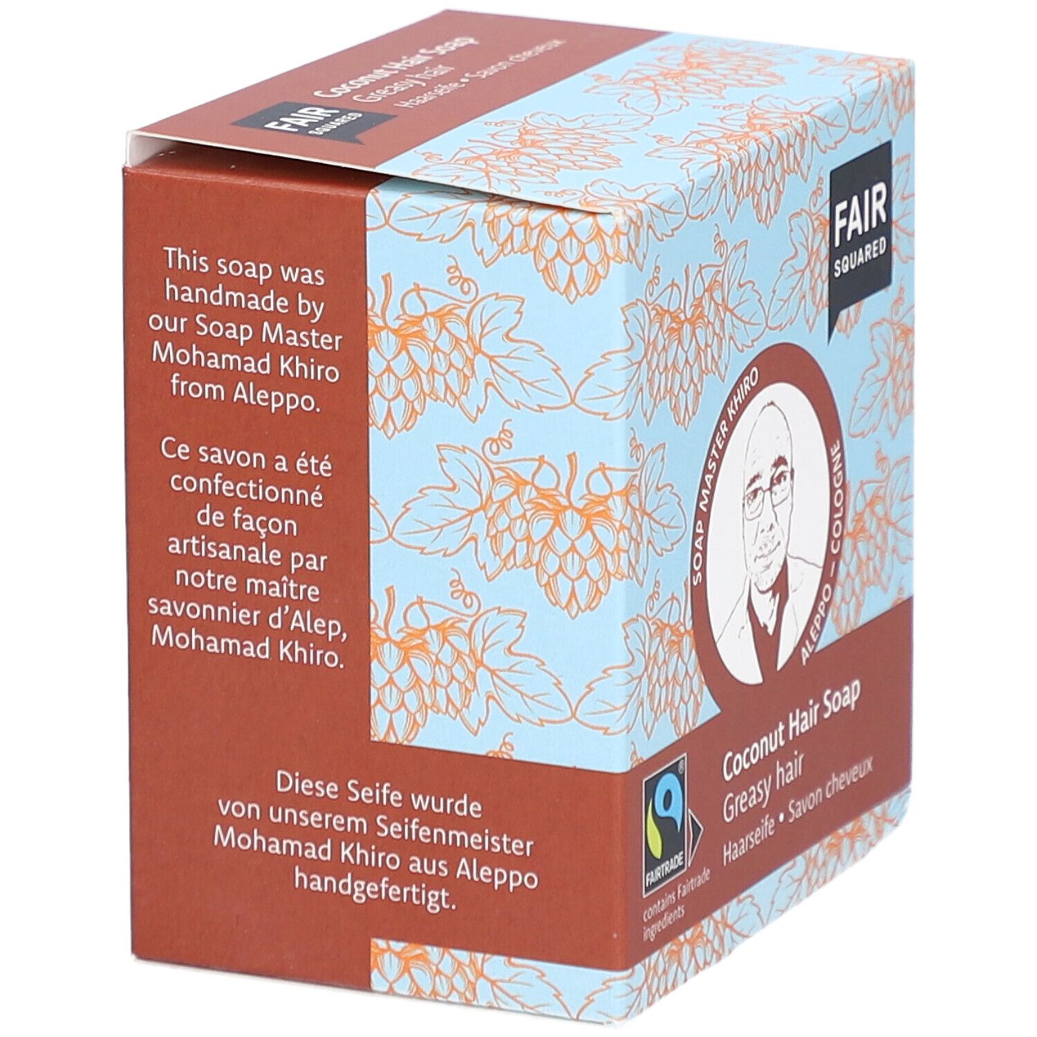 Boîte de FAIR SQUARED Haarseife Coco. Inscription : FAIR SQUARED, Soap Master Khiro, fait à la main, label Fairtrade, label Vegan.