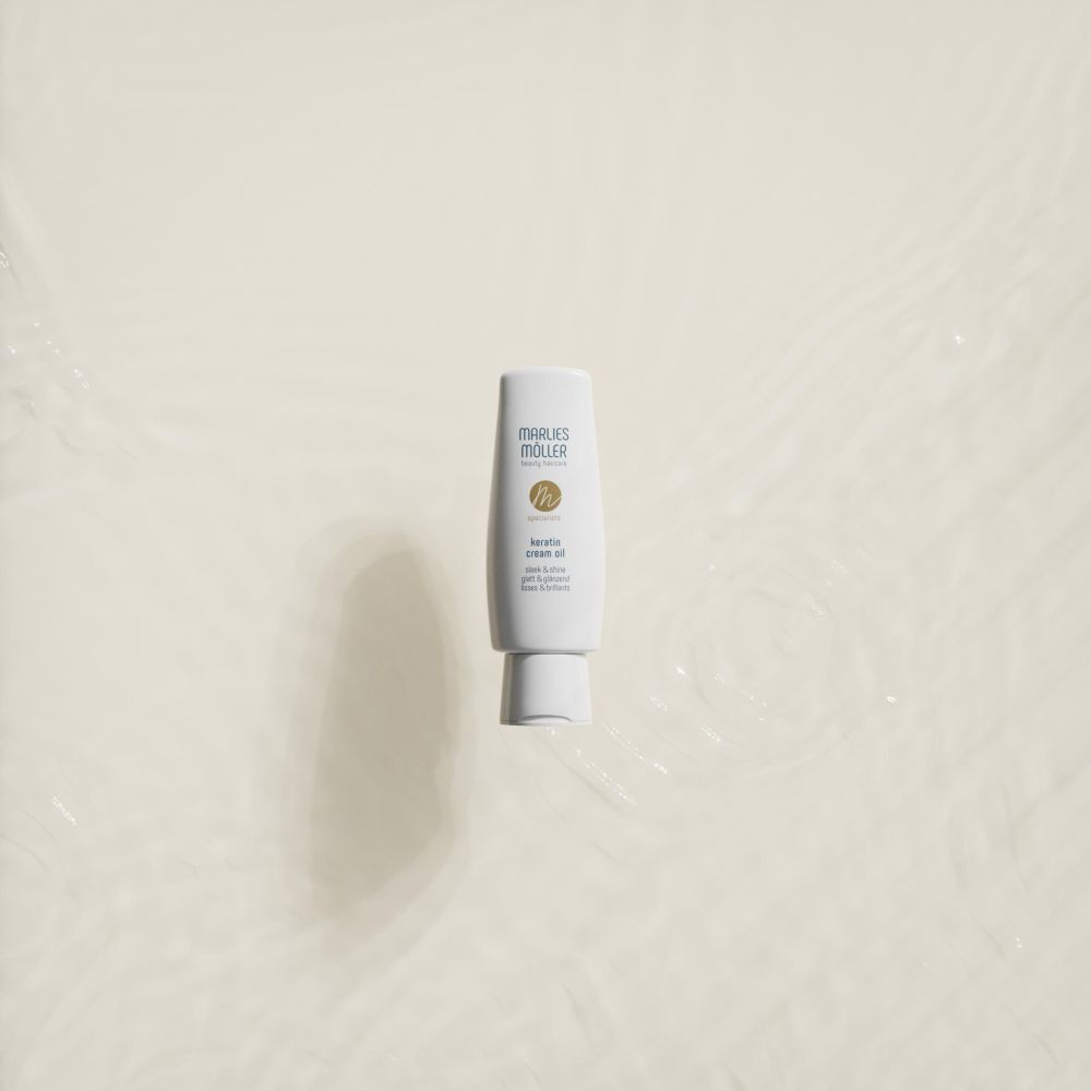 Bouteille Marlies Möller Keratin Cream Oil flotte dans l'eau.