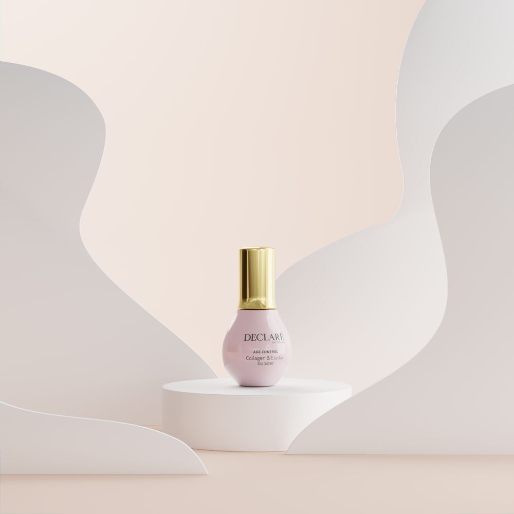 Flacon rose sur socle. DECLARÉ, AGE CONTROL Collagen & Elastin Booster. Fond avec formes.