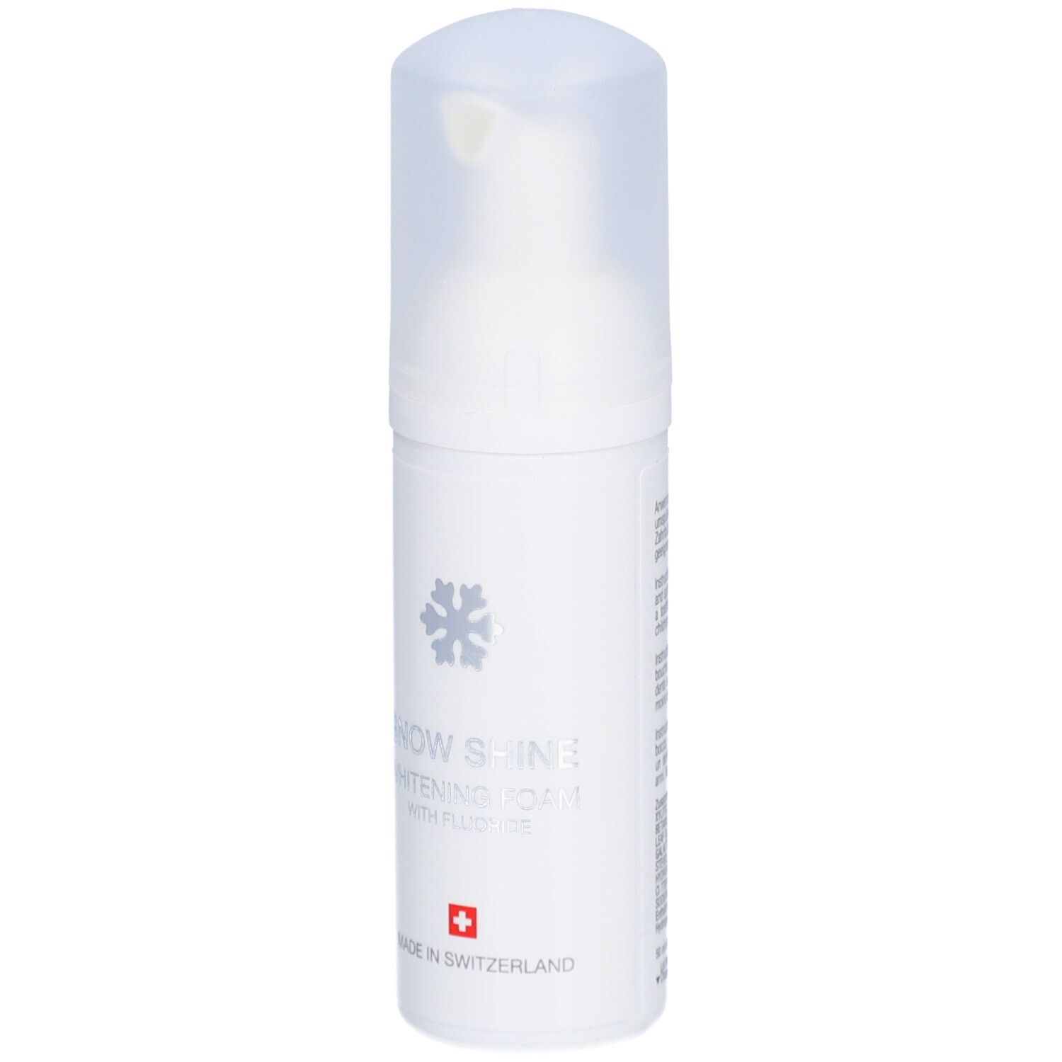Flacon blanc de mousse. Inscription: Snow Shine Whitening Foam avec fluorure. Croix suisse.