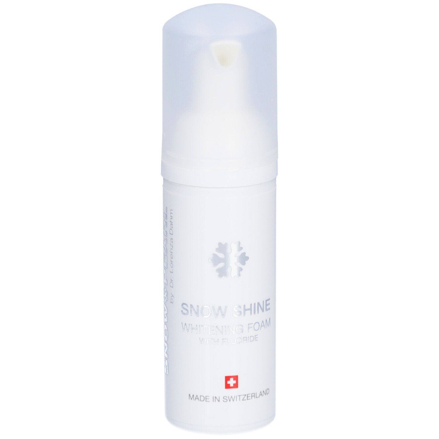 Flacon blanc de mousse. Inscription: Snow Shine Whitening Foam avec fluorure. Croix suisse.