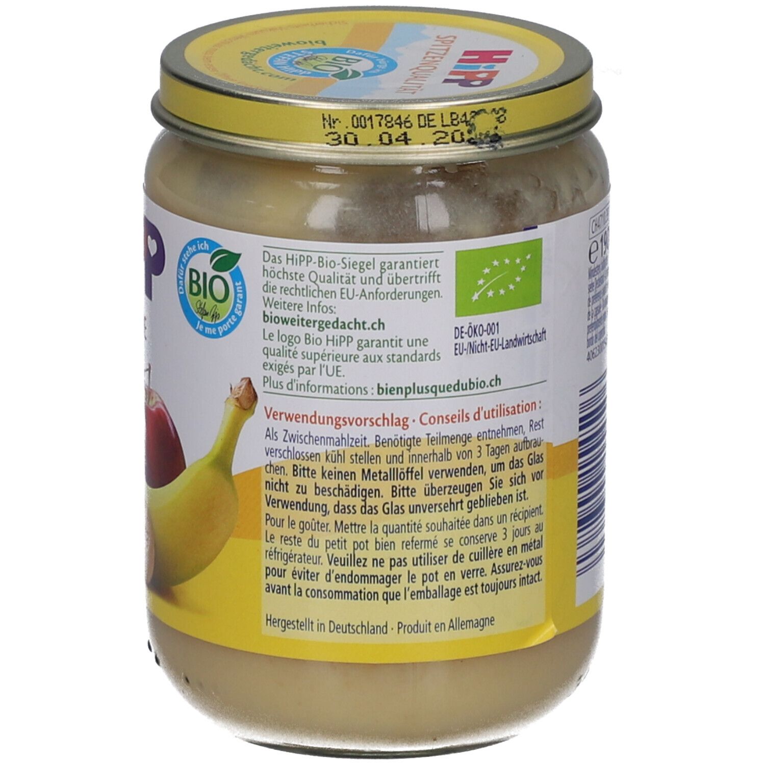 HIPP Bio-purée pour bébé en verre avec banane et pomme. Étiquette jaune avec sceau Bio et instructions d'utilisation.