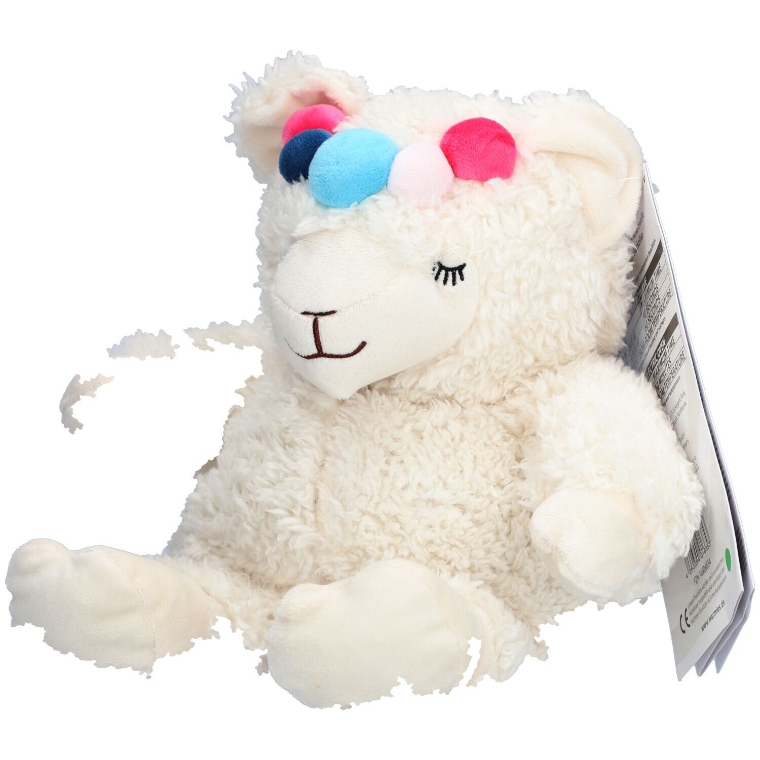 Peluche alpaga blanche avec pompons colorés sur la tête. Étiquette avec informations produit.