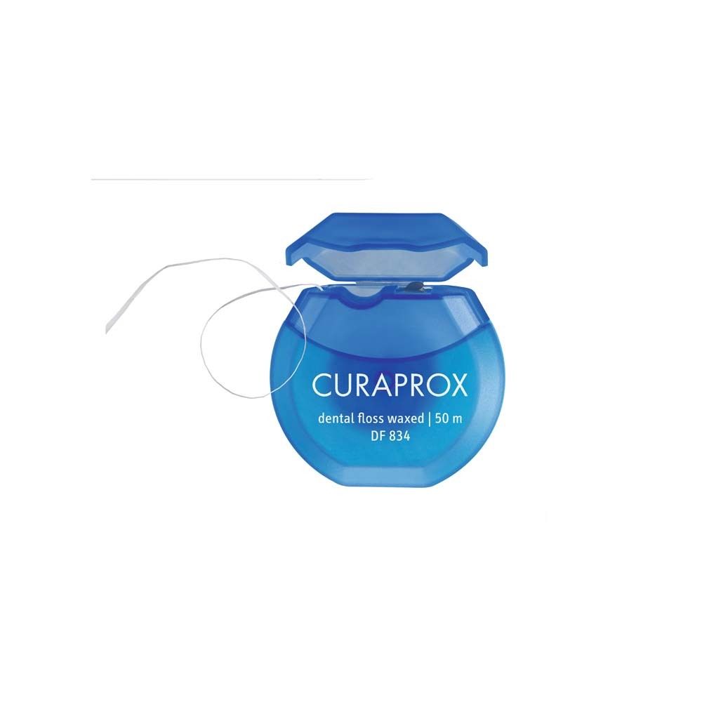 Bobine de fil dentaire bleu avec couvercle ouvert. Marque CURAPROX, texte "dental floss waxed".