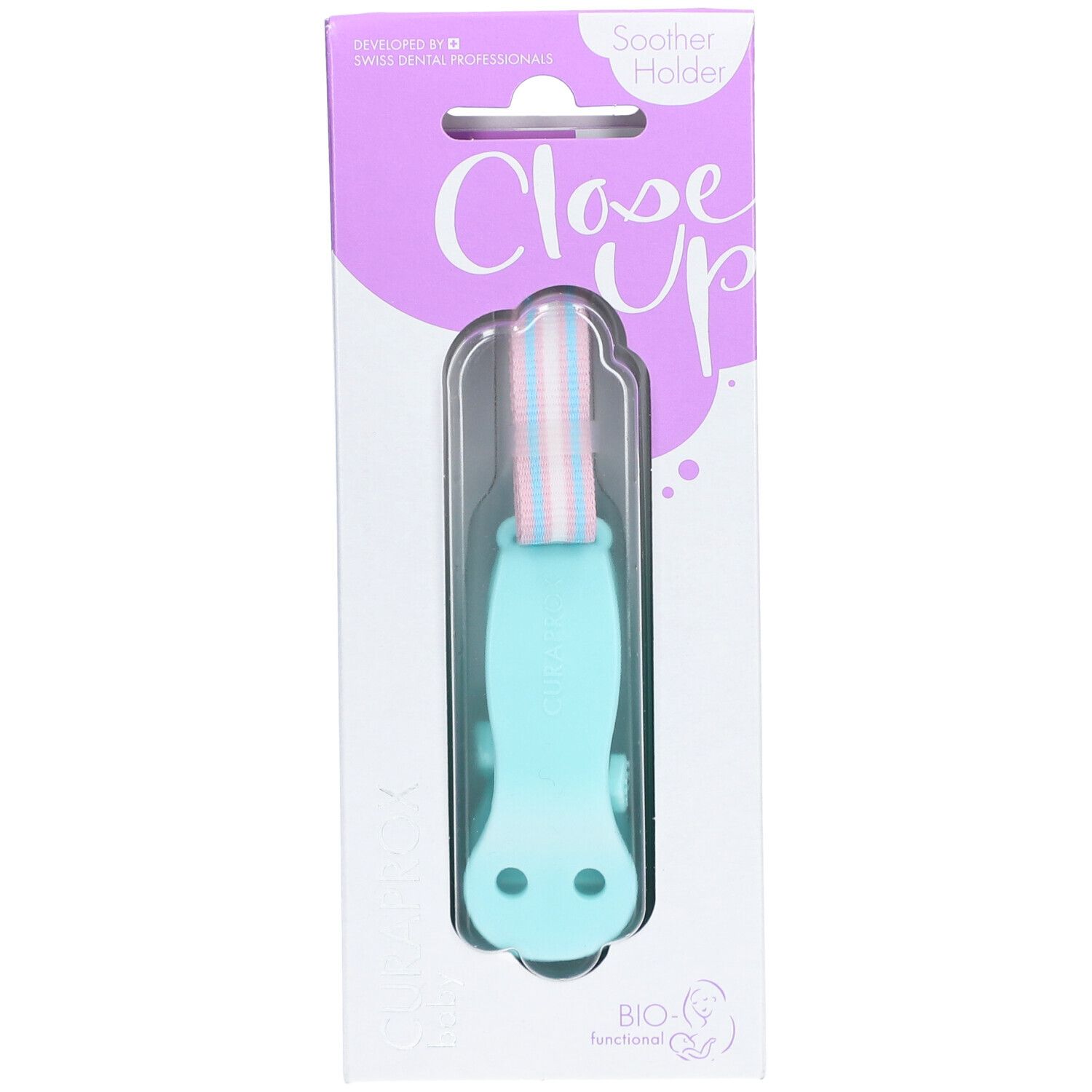 Attache-sucette turquoise dans son emballage. Visible : CURAPROX, Close Up, BIO-Fonctionnel. Attache avec bande rose et bleue.
