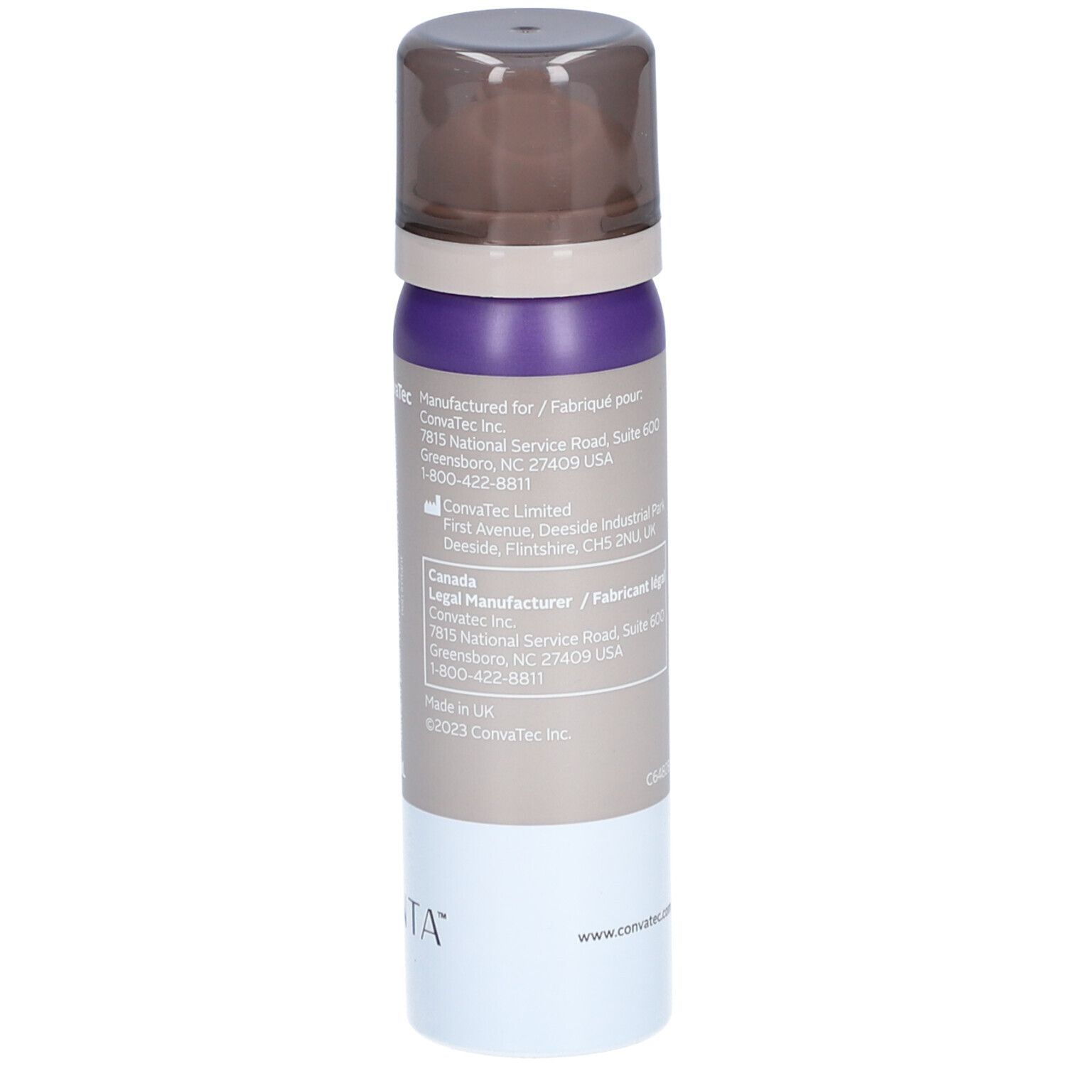 Flacon spray avec bouchon marron, partie centrale violette et beige, base blanche. Inscriptions: Adresse du fabricant, ConvaTec.
