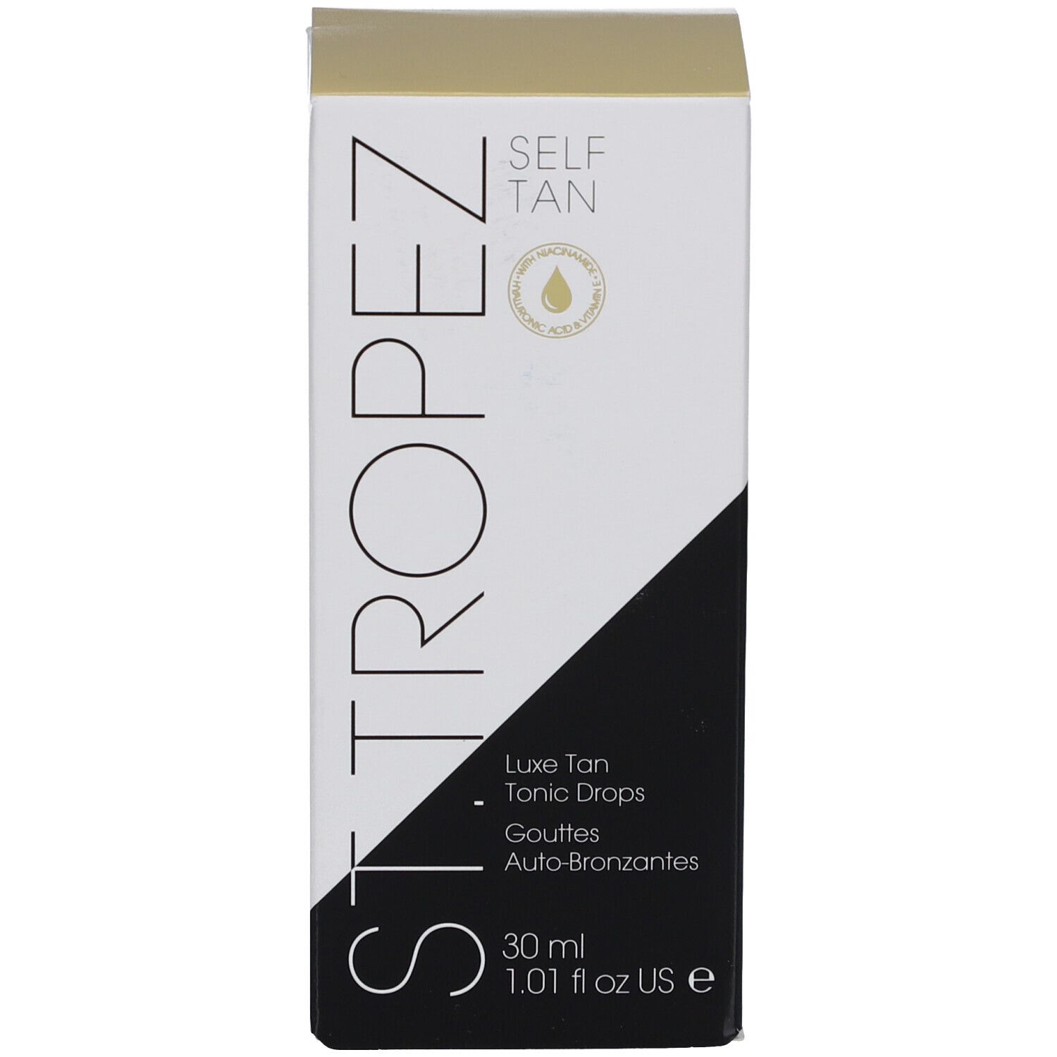 Boîte blanche avec design noir et doré. Inscription: SELF TAN, Luxe Tan Tonic Drops.