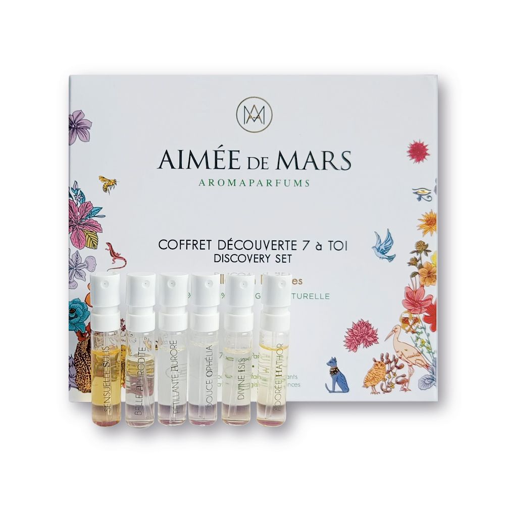 Coffret découverte avec 7 échantillons de parfum. Boîte blanche avec illustrations florales et nom du produit. Échantillons en flacons.