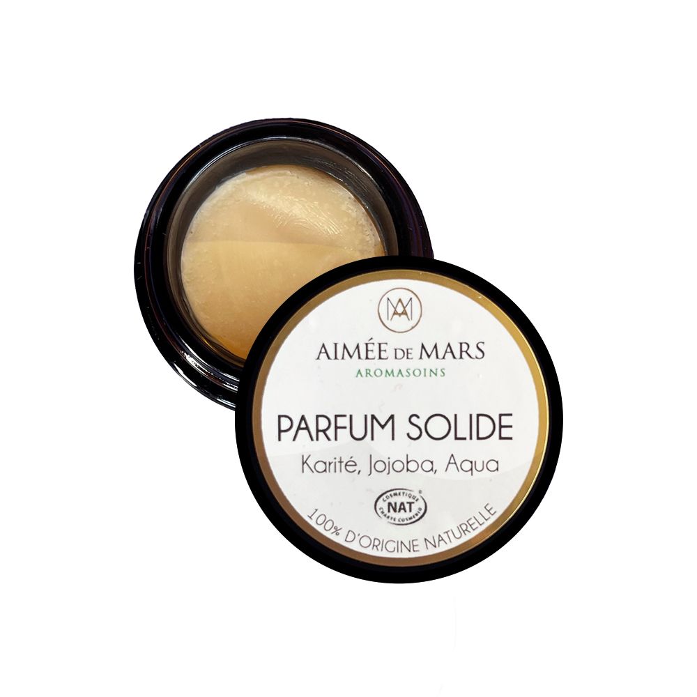 Petit pot rond avec couvercle noir. Inscription "PARFUM SOLIDE" et ingrédients sur le couvercle.