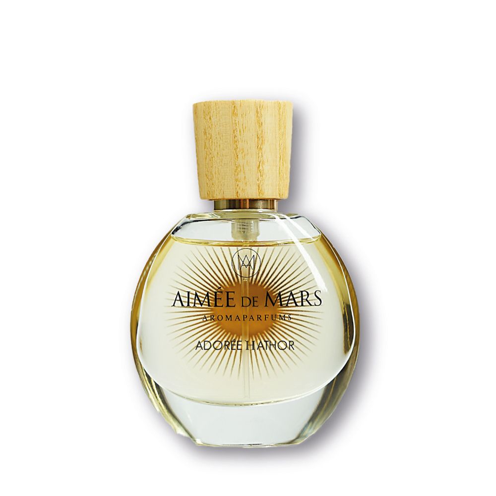 Flacon rond en verre avec bouchon en bois. Inscription: AIMÉE DE MARS, ADORÉE HATHOR. Aromaparfum.