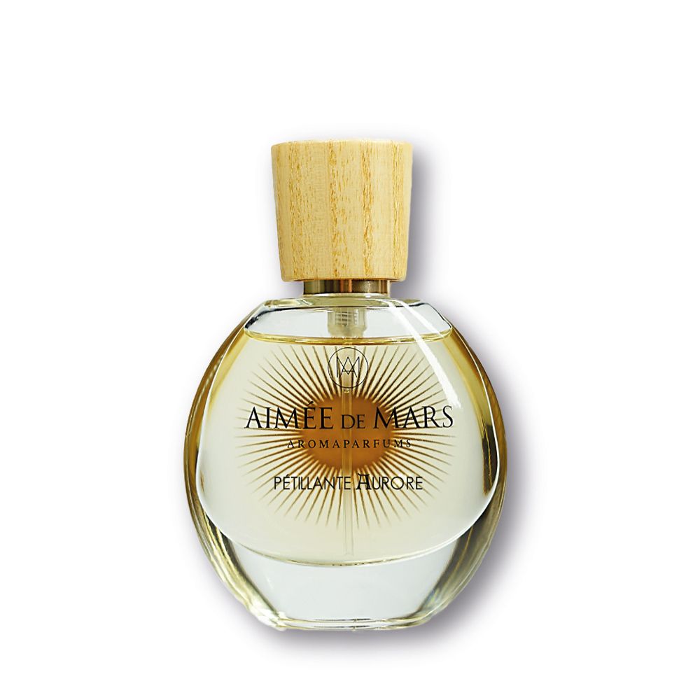 Flacon rond en verre avec bouchon en bois. Inscription : Aimée de Mars, Pétillante Aurore. Aromaparfum.