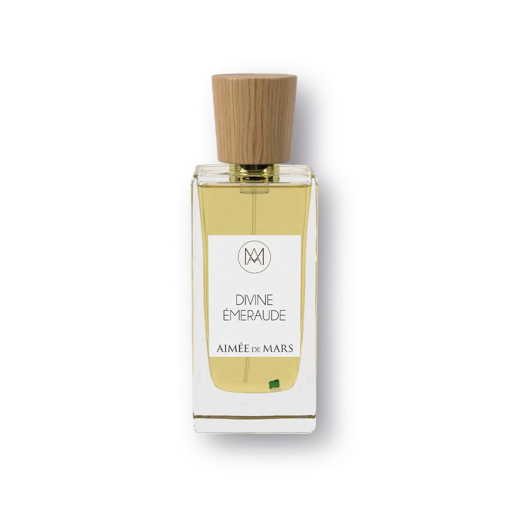 Flacon avec bouchon en bois. Inscription: Divine Émeraude, Aimée de Mars. Accent vert.