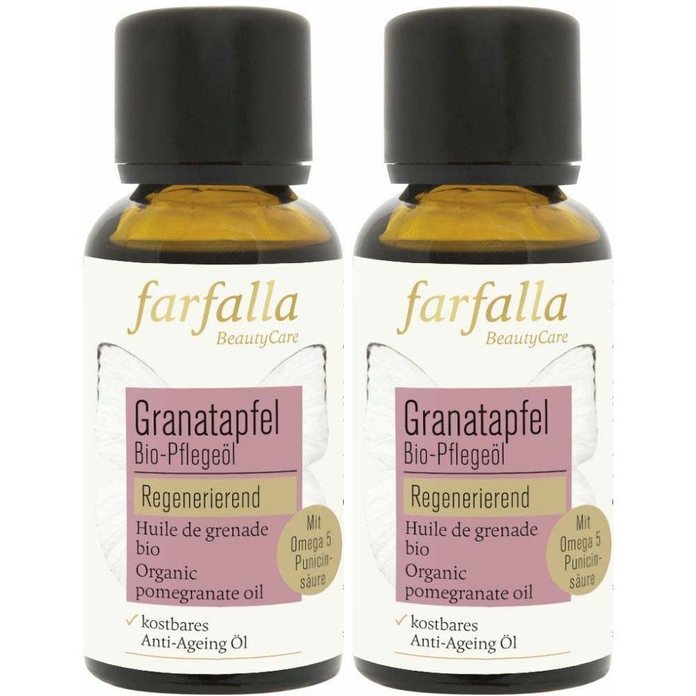 Deux flacons d'huile de soin bio à la grenade. Bouchon noir, flacon transparent avec liquide jaunâtre. Étiquette avec informations.