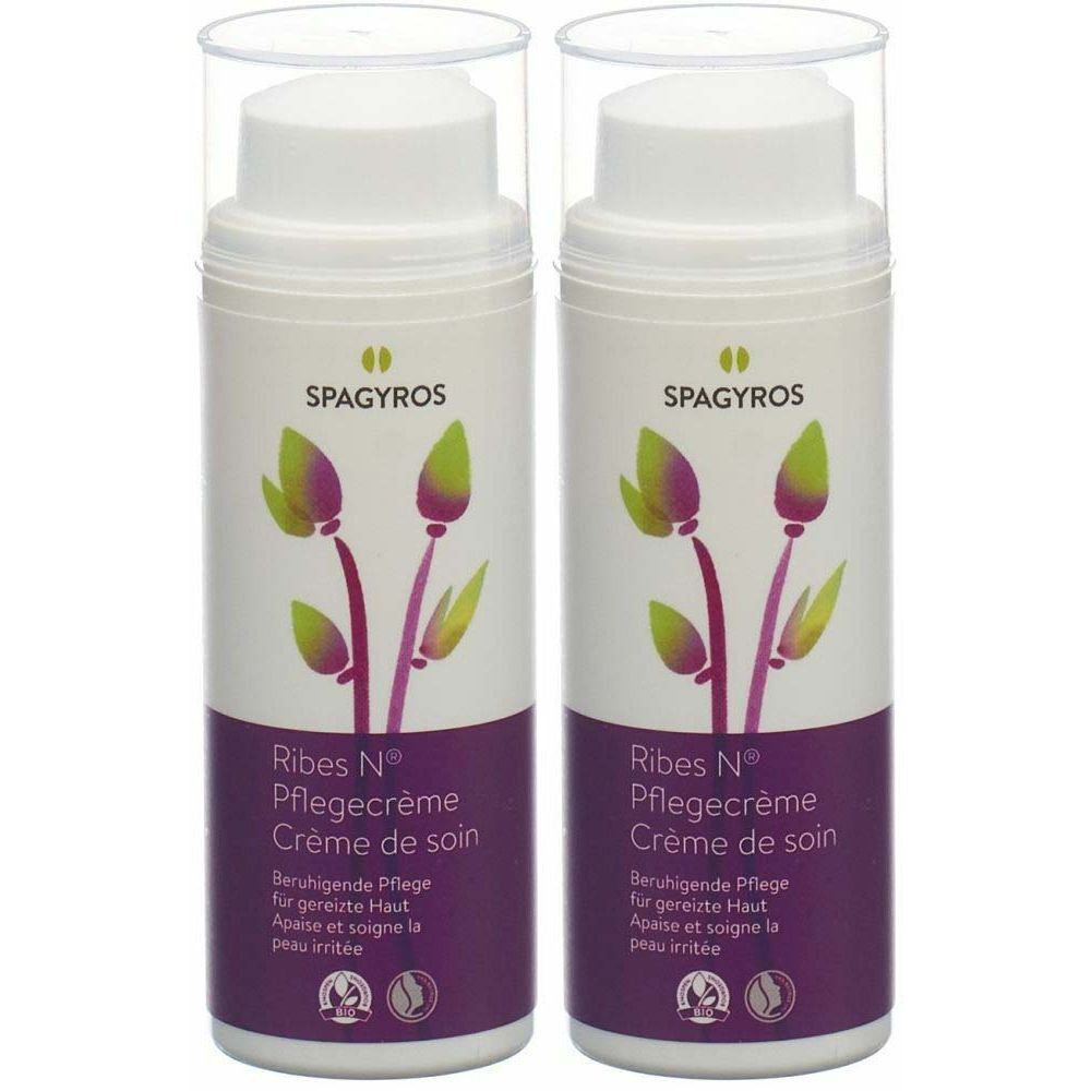 Deux flacons de crème de soin SPAGYROS Ribes N®. Flacons pompes blancs avec motif floral et indications en allemand et français.
