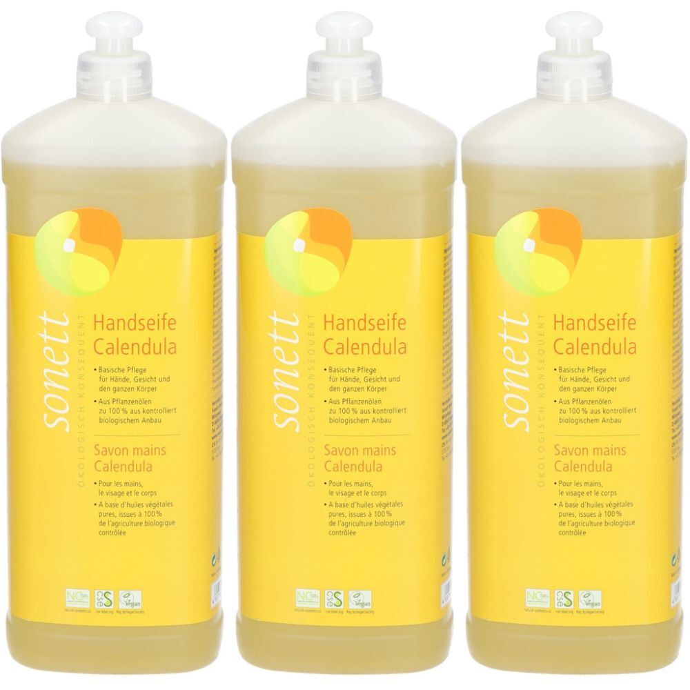 Trois flacons de savon liquide. Étiquettes jaunes avec nom et logo du produit. Liquide transparent. Têtes de pompe blanches.