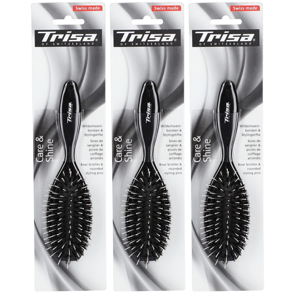 Trois brosses à cheveux emballées. Brosses noires avec manche, poils et picots arrondis. Marque : Trisa.