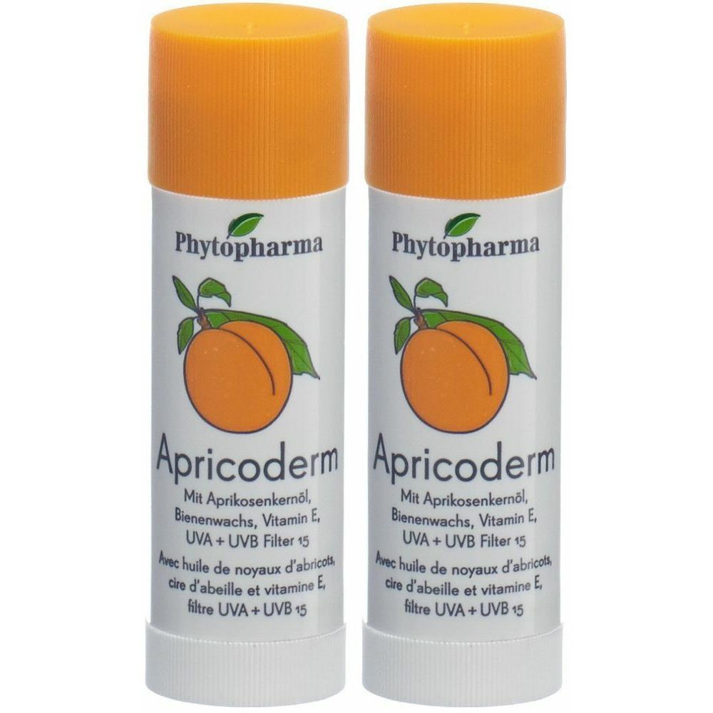 Deux sticks avec bouchons orange. Inscription: Phytopharma Apricoderm. Illustration d'abricot. Contient huile de noyau d'abricot, cire d'abeille, vitamine E, filtre UVA+UVB 15.