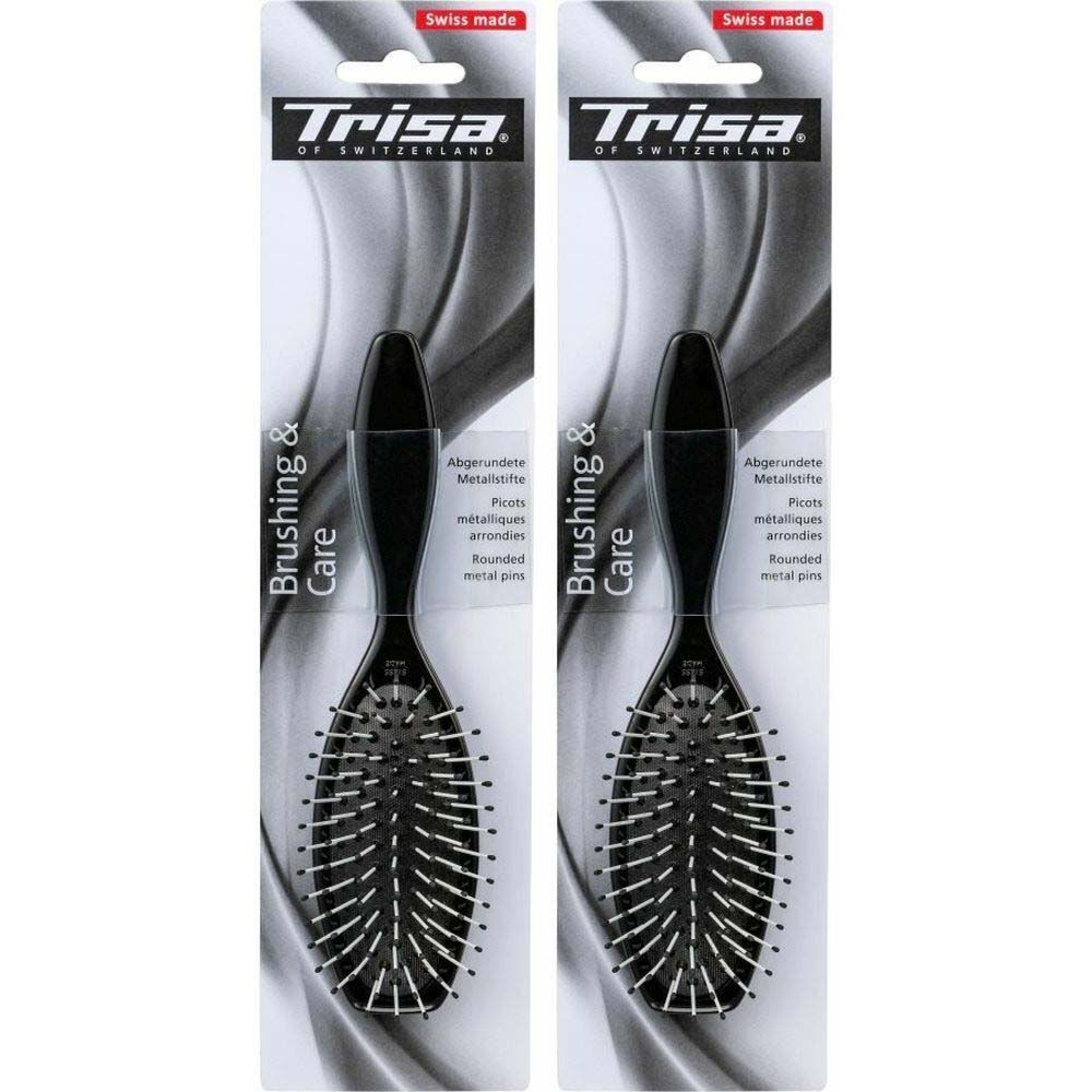 Deux brosses à cheveux noires dans leur emballage. Marque Trisa, inscription "Brushing & Care". Picots métalliques arrondis.