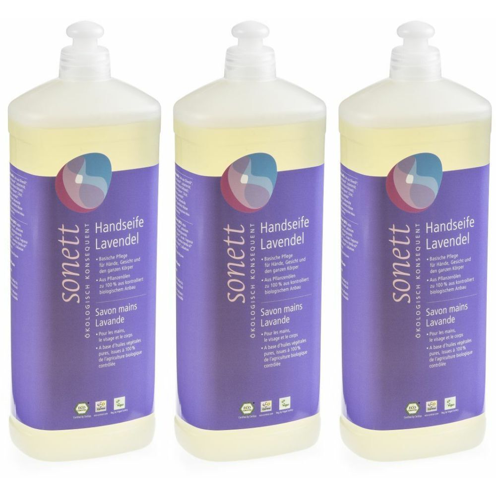 Trois flacons de savon liquide. Étiquettes violettes avec nom et logo du produit. Distributeur blanc.