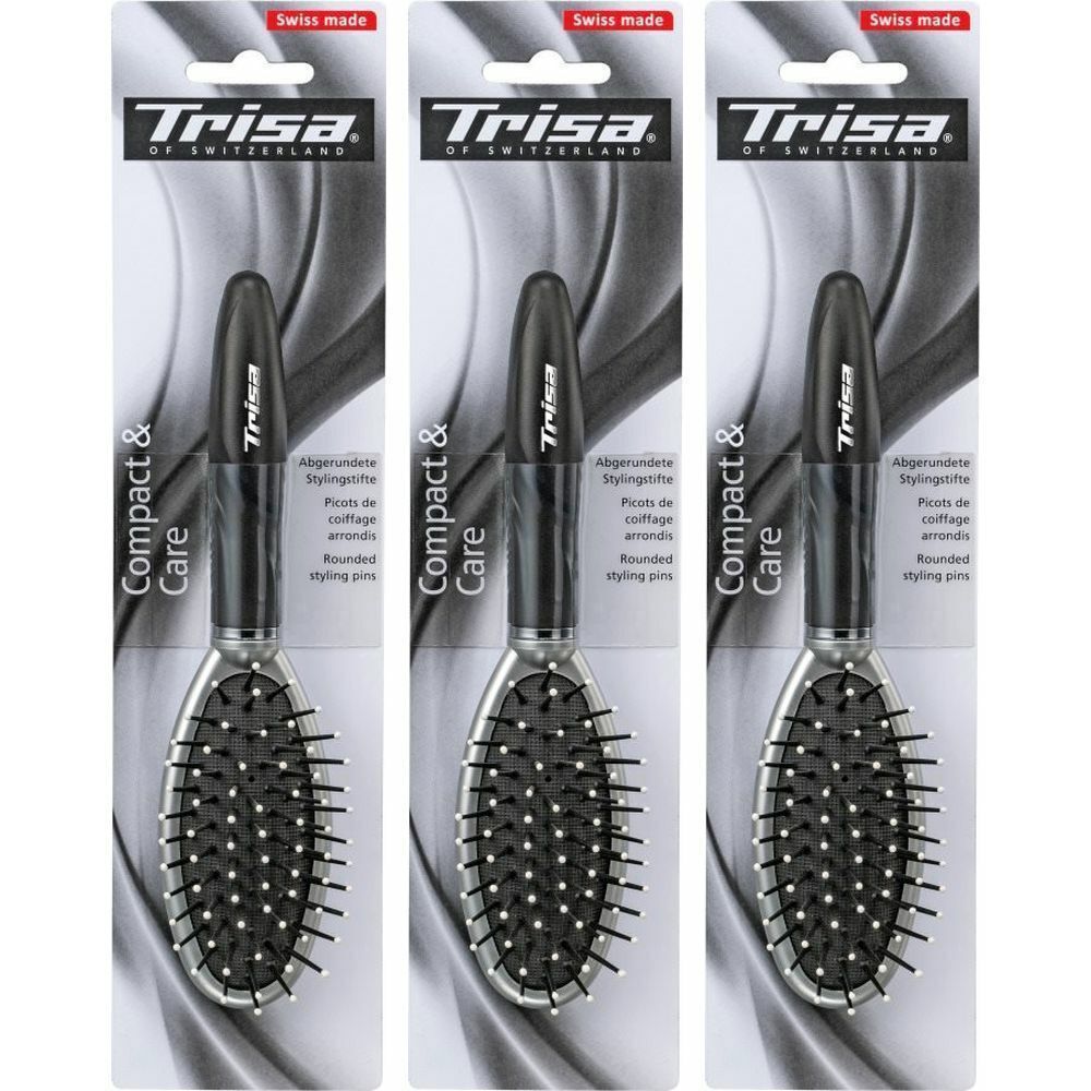 Trois brosses à cheveux emballées. Manche noir, surface de brossage ovale avec poils noirs et pointes blanches. Marque : Trisa.