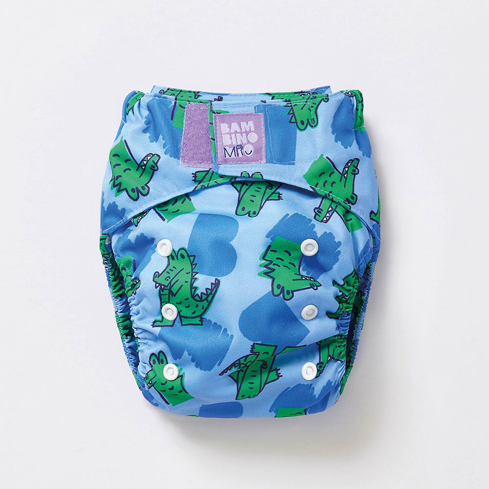 Couche lavable bleue à motifs crocodiles. Boutons-pression et logo Bambino Mio.