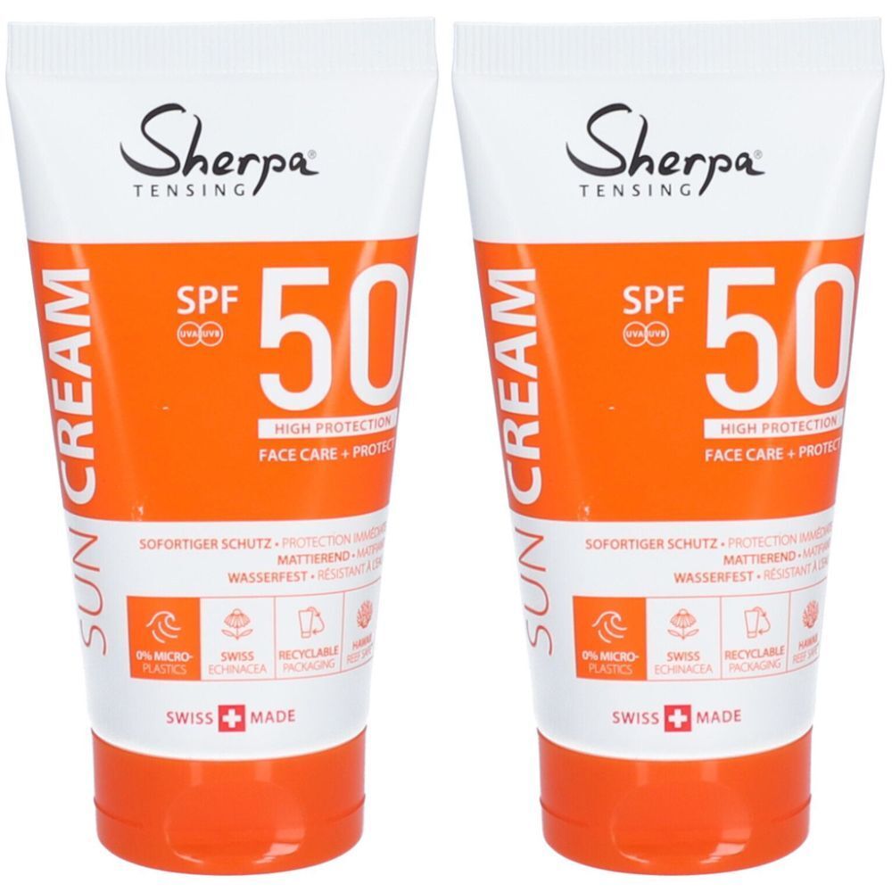 Deux tubes de crème solaire avec bouchon blanc et partie centrale orange. Inscription : Sherpa Tensing SPF 50, Sun Cream.