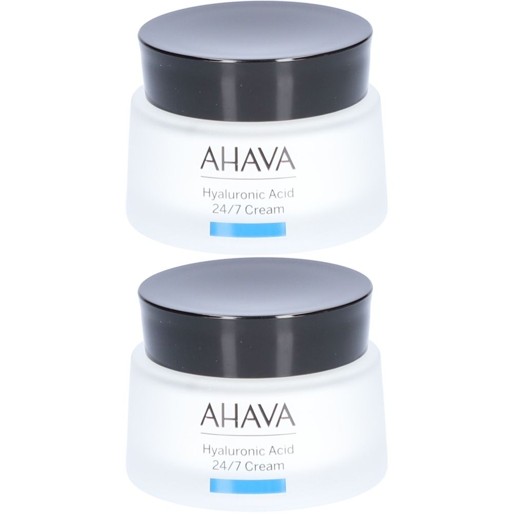 Deux pots de crème AHAVA avec couvercles noirs. Inscription: Acide Hyaluronique 24/7 Cream.