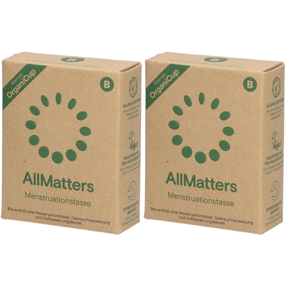 Deux boîtes en carton. Inscription "OrganiCup", "AllMatters Menstruationstasse". Label végan.