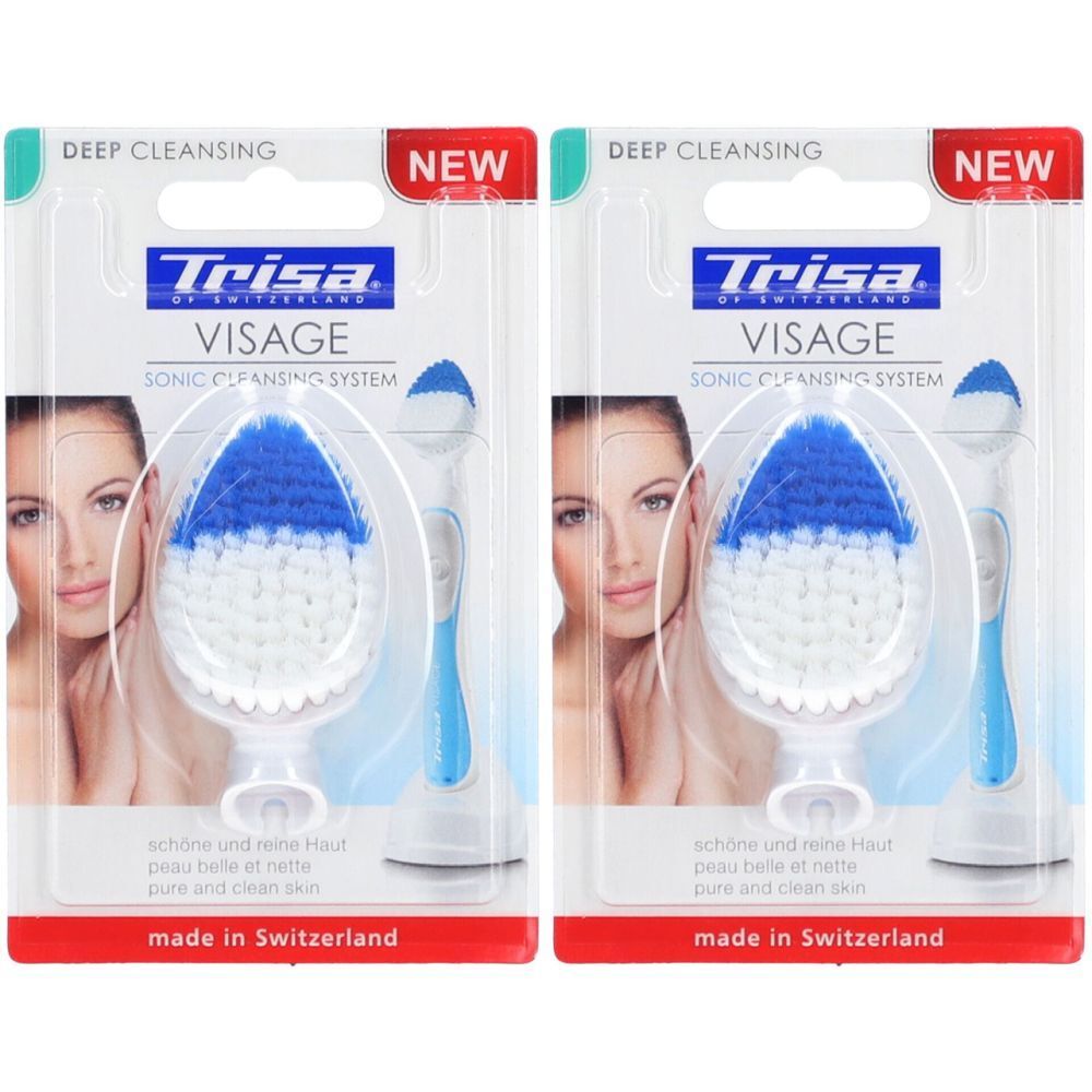 Deux brosses nettoyantes visage TRISA Visage en emballage. Soies bleues et blanches, manche. Inscriptions : Deep Cleansing, New, made in Switzerland.