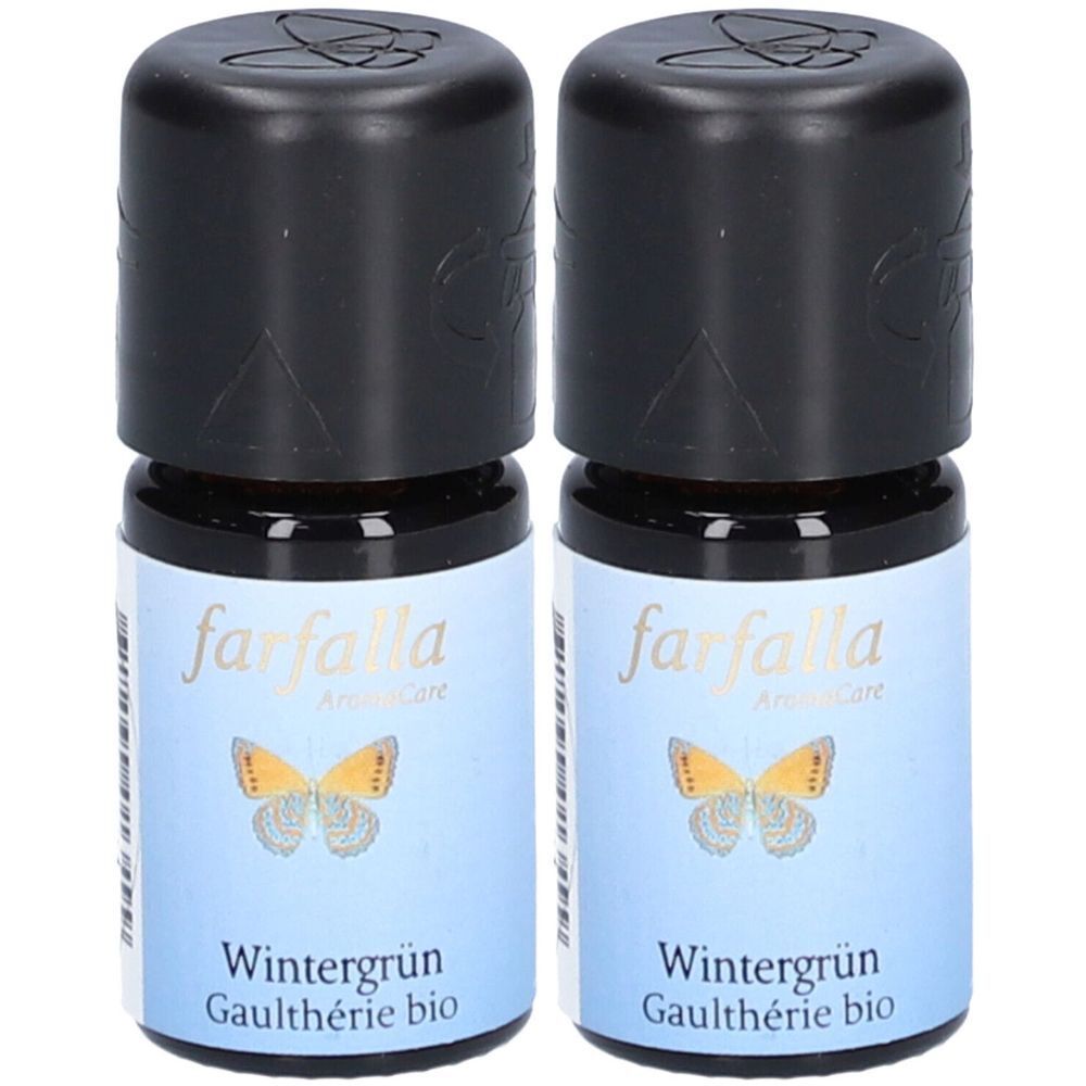 Deux petites bouteilles avec bouchons noirs. Les étiquettes indiquent "farfalla AromaCare" et "Wintergrün Gaulthérie bio".