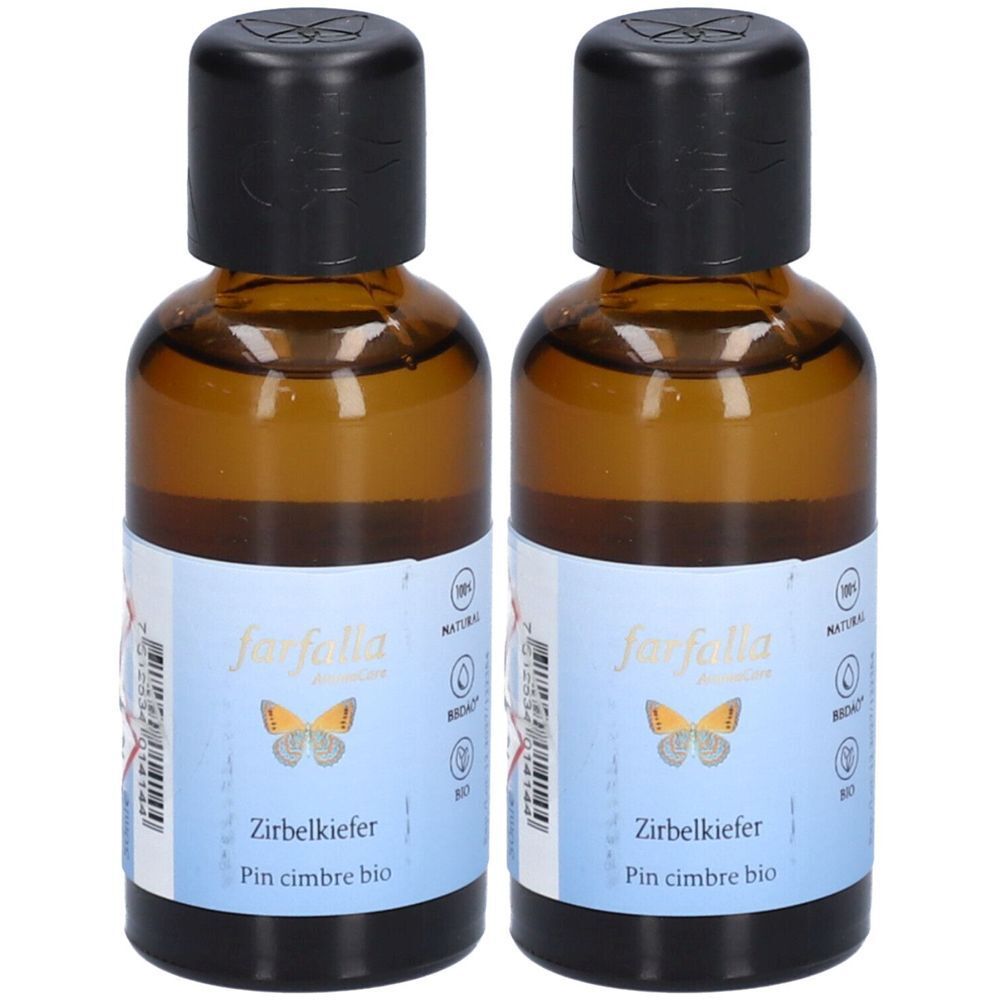 Deux flacons en verre brun avec bouchons noirs. Étiquettes bleues avec texte et papillon. "Zirbelkiefer" et "Pin cimbro bio".