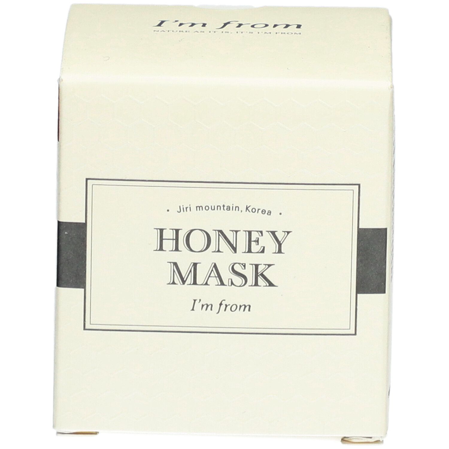 Boîte en carton beige. Inscription: HONEY MASK, I'm from. Forme carrée.
