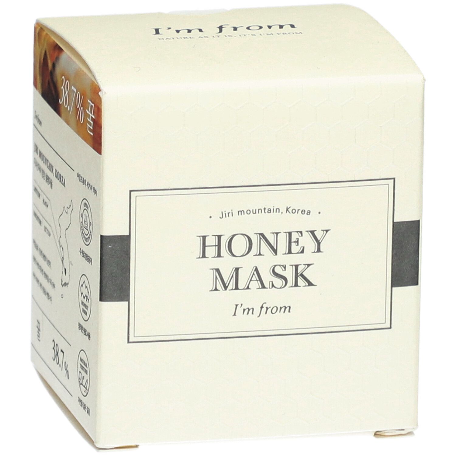 Boîte en carton beige. Inscription: HONEY MASK, I'm from. Texte, 38,7%. Forme carrée.