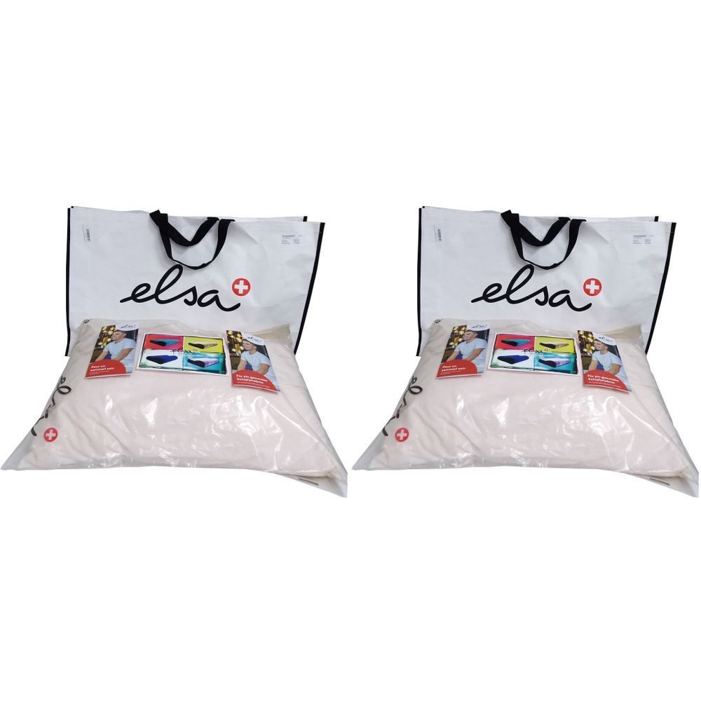 Deux oreillers ELSA emballés. Sacs blancs avec poignées noires et logo. Croix suisse.