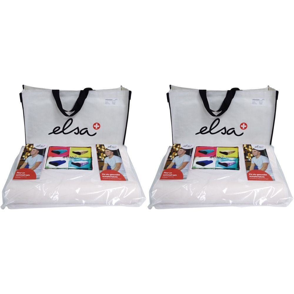 Deux coussins de nuque blancs emballés dans du plastique, avec brochures et sacs. Le mot "elsa" est visible.