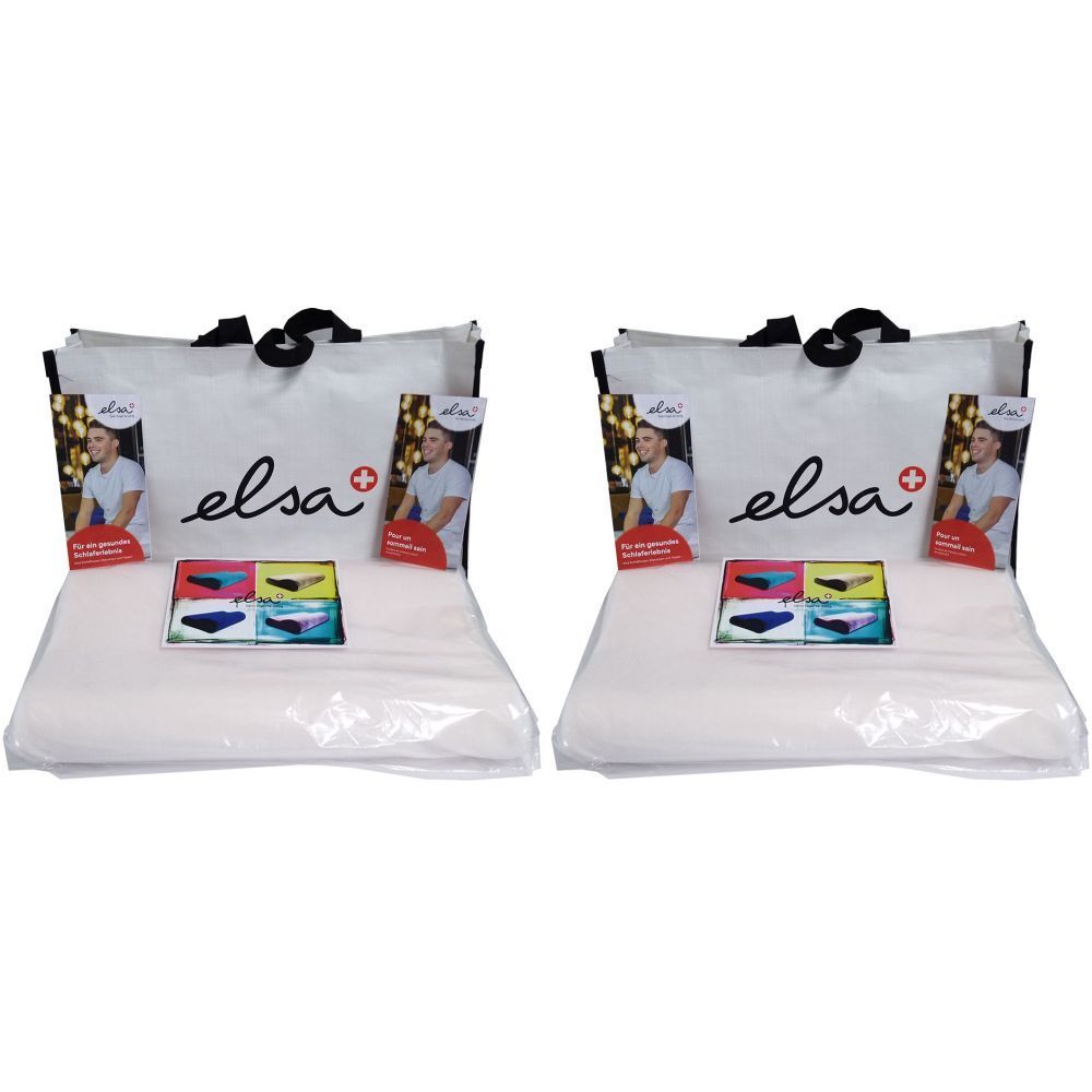 Deux coussins de nuque ELSA dans des sacs. Le sac porte le nom "elsa" et une croix rouge. Les coussins sont emballés dans du plastique.