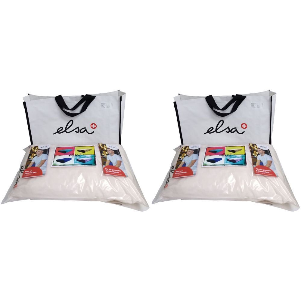 Deux oreillers emballés dans du plastique, avec des dépliants. Au-dessus, un sac blanc avec une poignée noire et le logo "elsa".