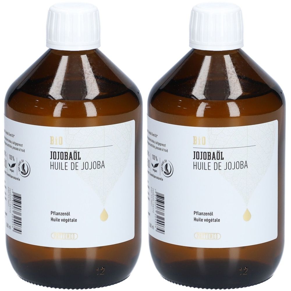 Deux flacons en verre brun avec bouchons blancs. Les étiquettes indiquent "BIO JOJOBAÖL" et "HUILE DE JOJOBA".
