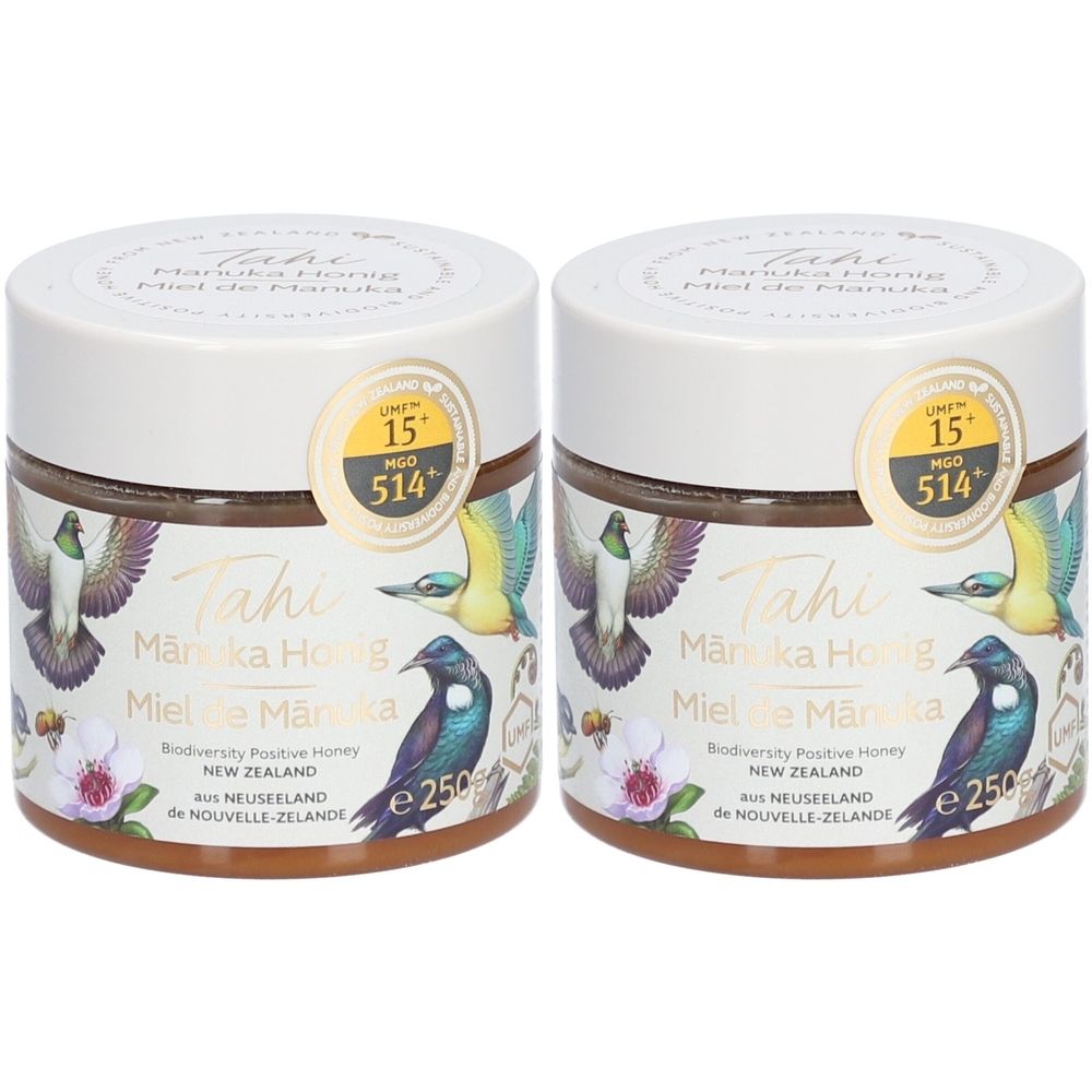 Deux pots de miel avec étiquettes. Inscription: Tahi, Mānuka Honig, UMF 15+, MGO 514+. Motifs d'oiseaux et de fleurs.