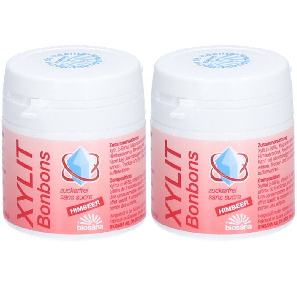 Deux pots blancs avec étiquettes roses. Inscription: XYLIT Bonbons, sans sucre, framboise. Logo: diamant bleu.